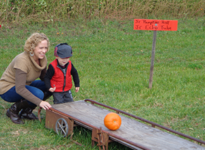 Child enjoying PA Field Trip highlight, pumpkin rolling