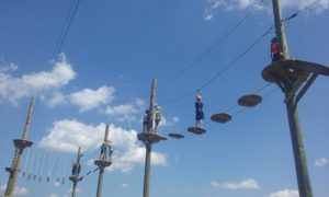 People exploring the aerial adventure ropes course with zipline in PA