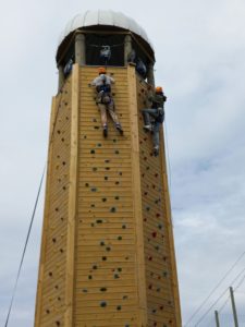 People racing to the top of the silo climbing wall
