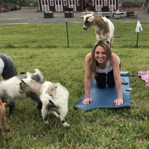 Woman surrounded by goats at Doylestown goat yoga