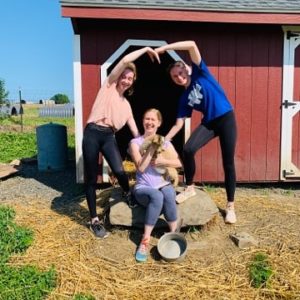 Three people with goat at Bucks county farm