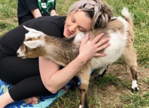 Woman hugging a goat