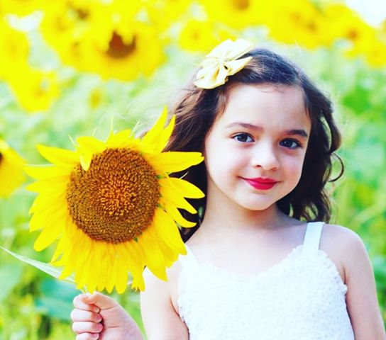 Professional photo of girl in sunflower field