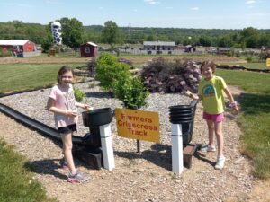 Two younger girls participating in fun farm activities at Hellerick's Bucks County Farm