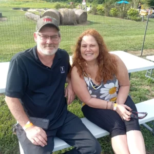 Couple at picnic table in Bucks county for celebration on a farm