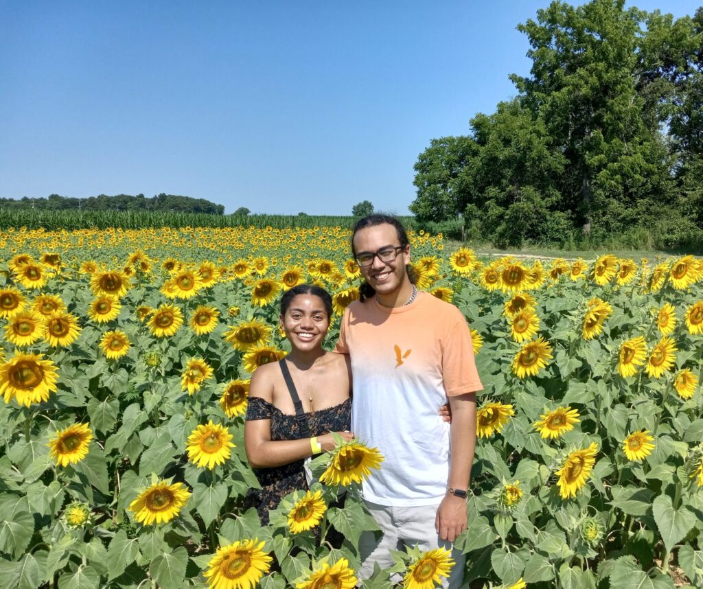 Two people enjoying sunflower season in Pennsylvania at Hellerick's Family Farm.